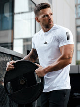 URBAN WOLFS men's white mesh dry-fit tee worn by athletic man holding weight plate in outdoor gym